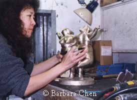 Chen inspects bronze casting